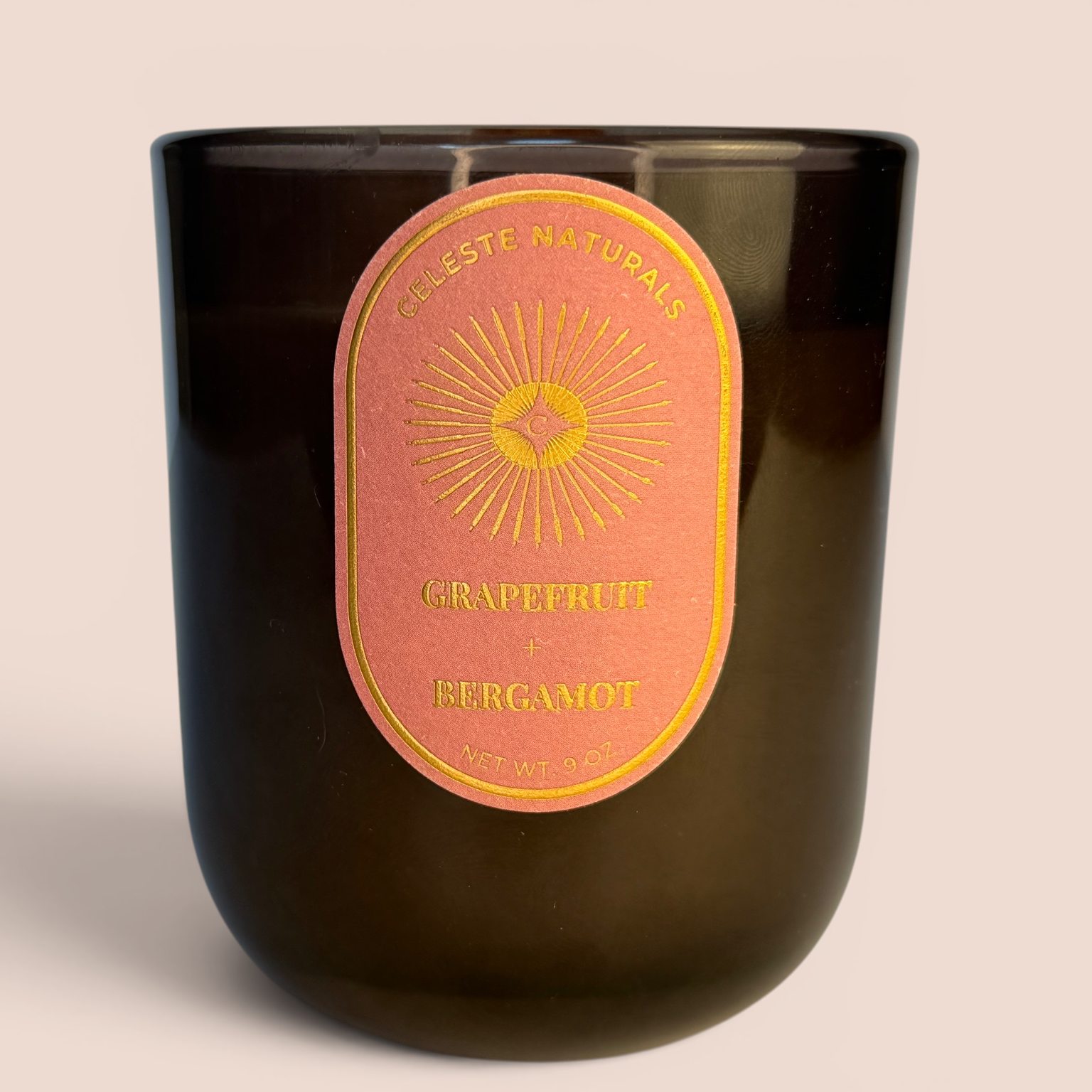 Celeste Naturals Grapefruit + Bergamot candle on a beige background