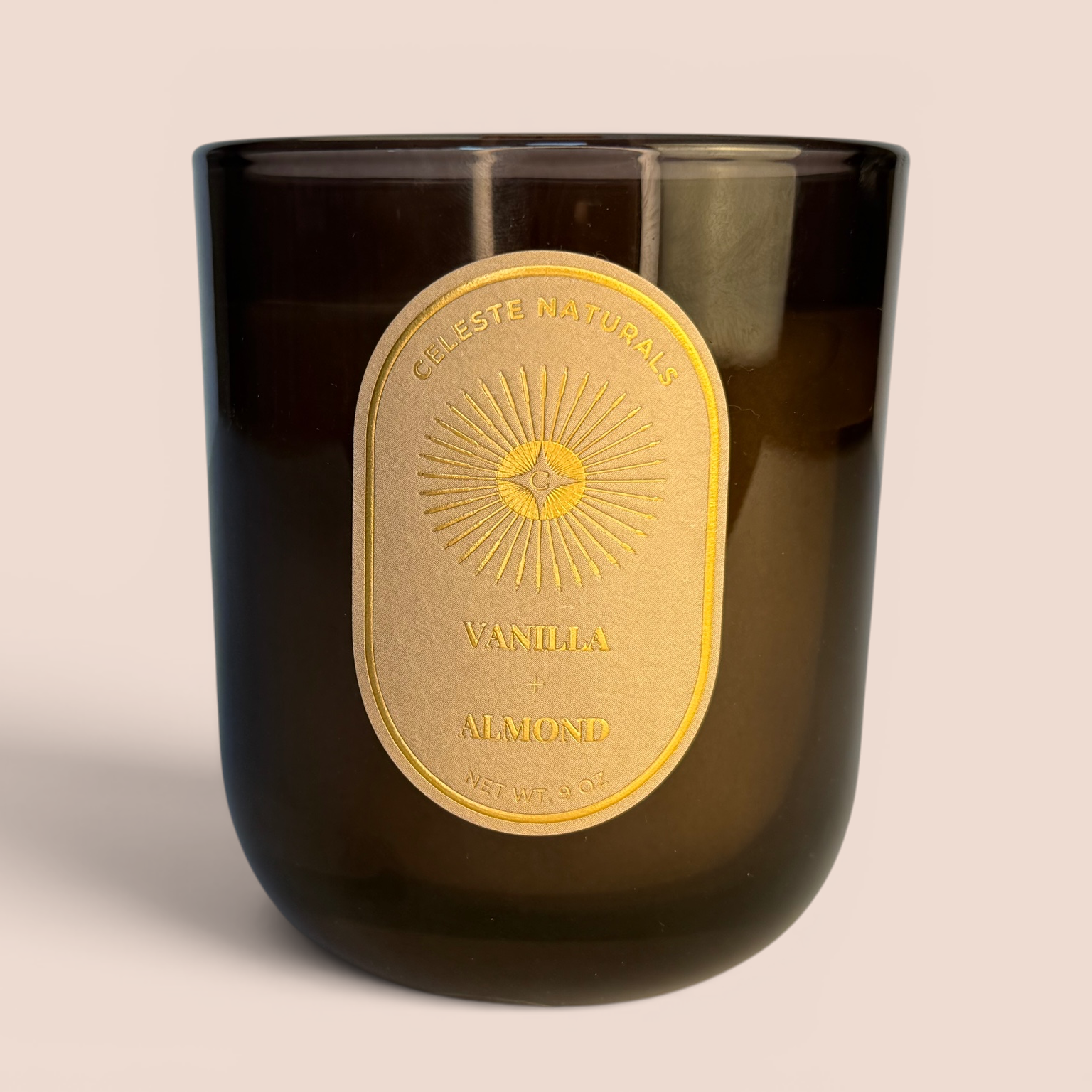 Celeste Naturals Vanilla + Almond candle in an amber jar