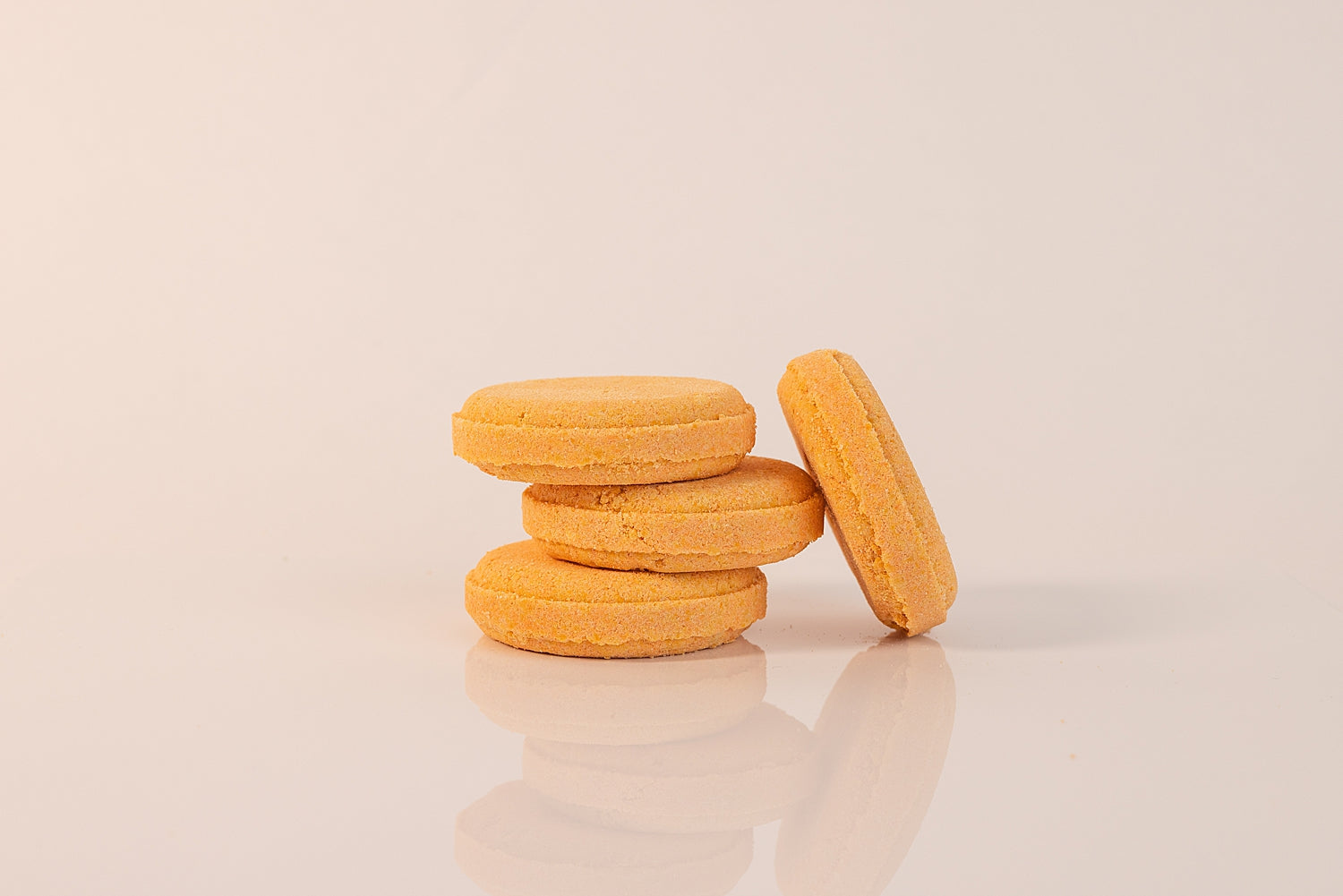 Stack of CELESTE NATURALS CITRUS shower steamer tablets on a beige background