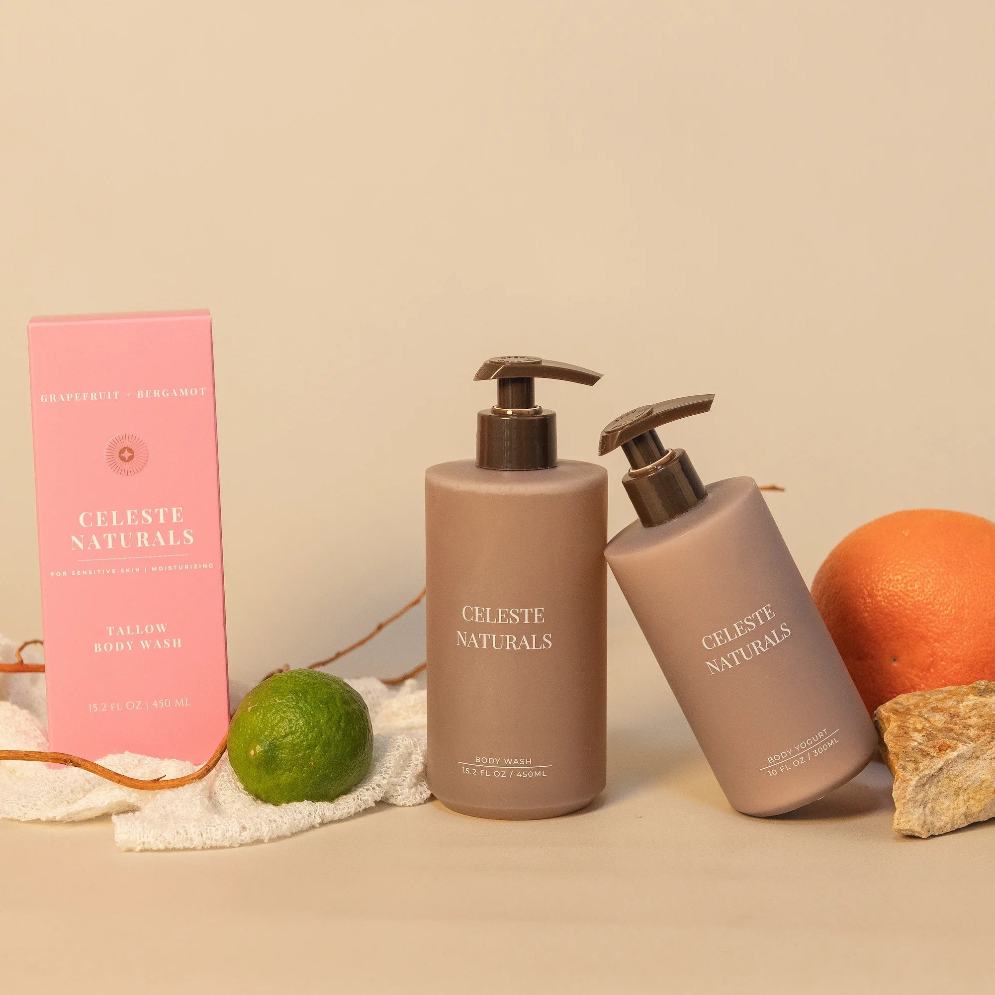Celeste Naturals Grapefruit + Bergamot Body Wash and Body Yogurt bottles next to a pink box