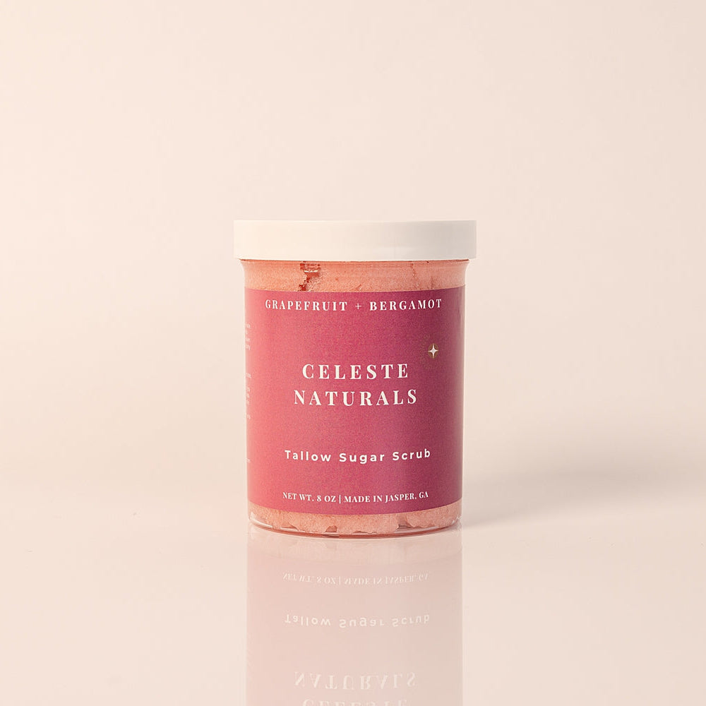 CELESTE NATURALS GRAPEFRUIT + BERGAMOT sugar scrub container on a light pink background
