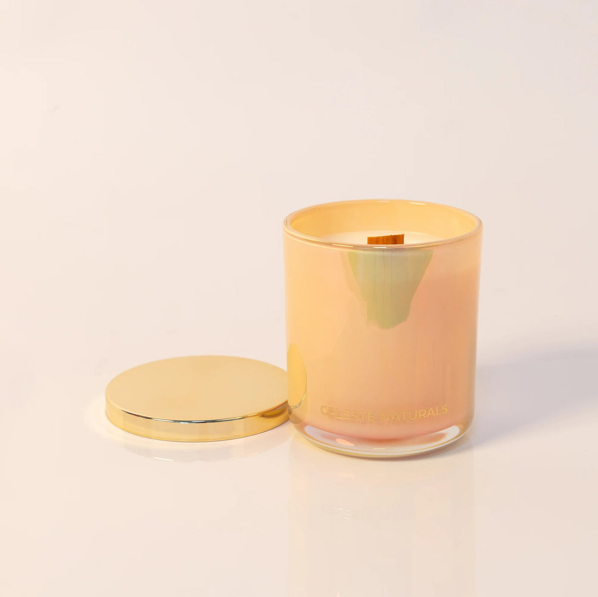 Celeste Naturals Vanilla + Almond candle in a beige jar with gold lid