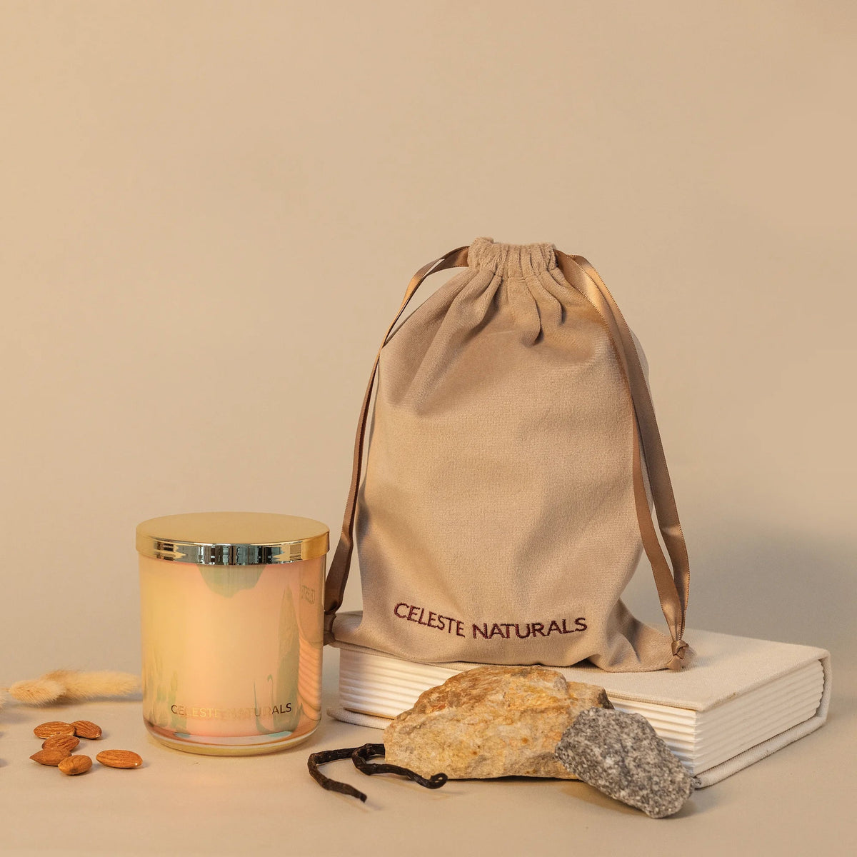 Celeste Naturals Vanilla + Almond candle in a beige glass jar with a gold lid