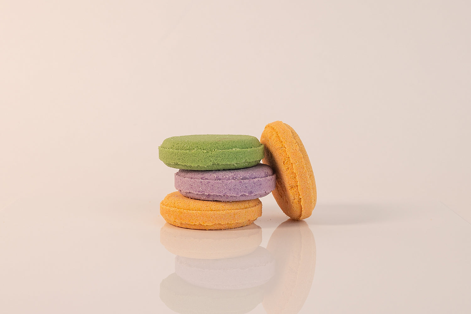 Stack of CELETE NATURALS shower steamers on a beige background